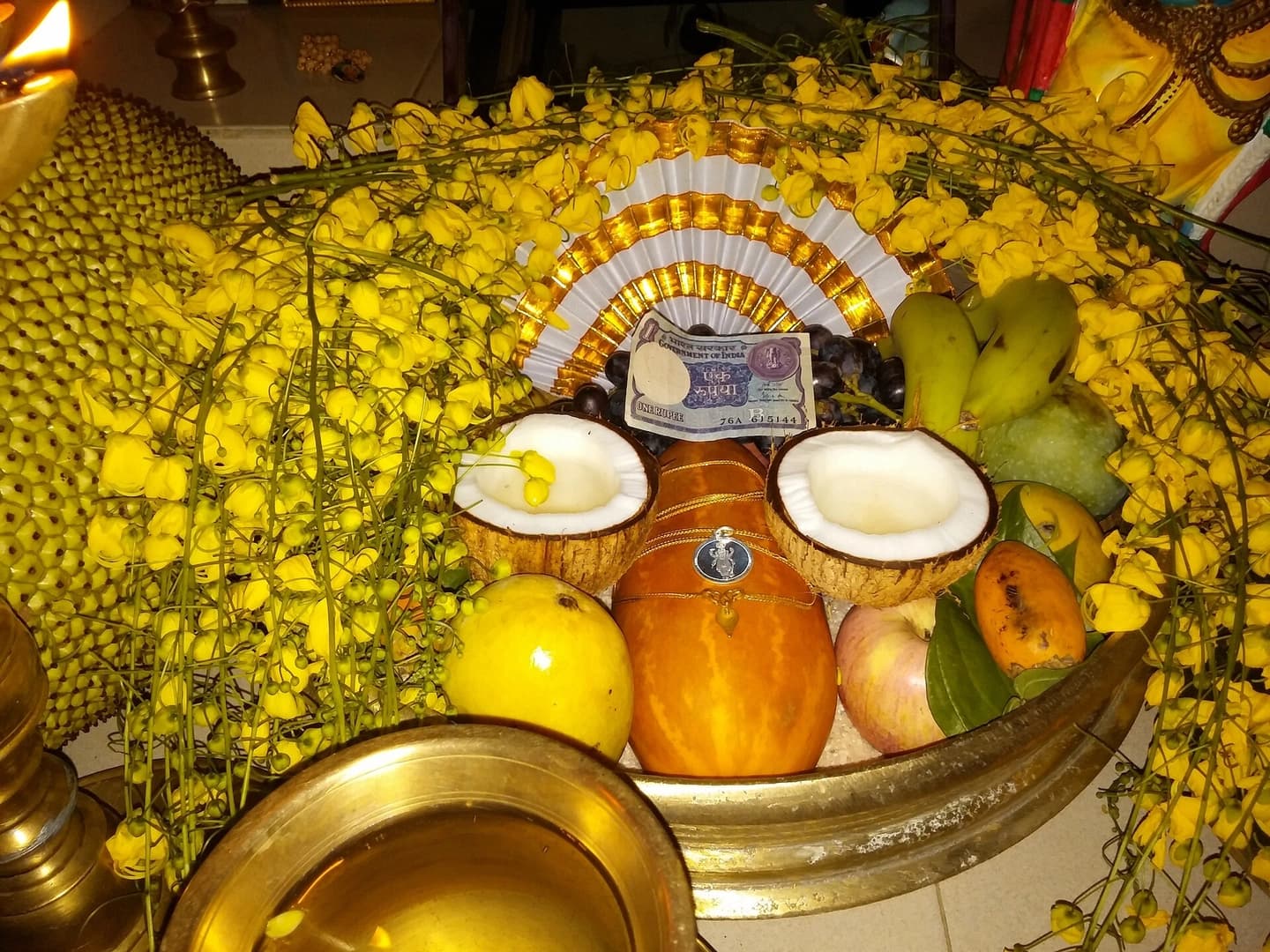 Vishukkani arrangement with golden Kani Konna flowers and Lord Krishna idol — Kerala New Year